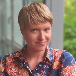 Head and shoulders of woman in colourful blouse